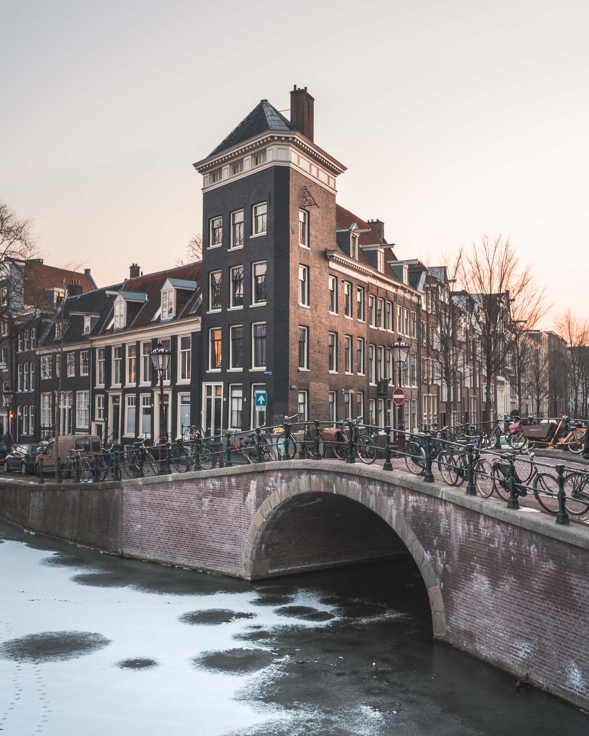 Frozen canals in winter at sunset in Amsterdam The Netherlands