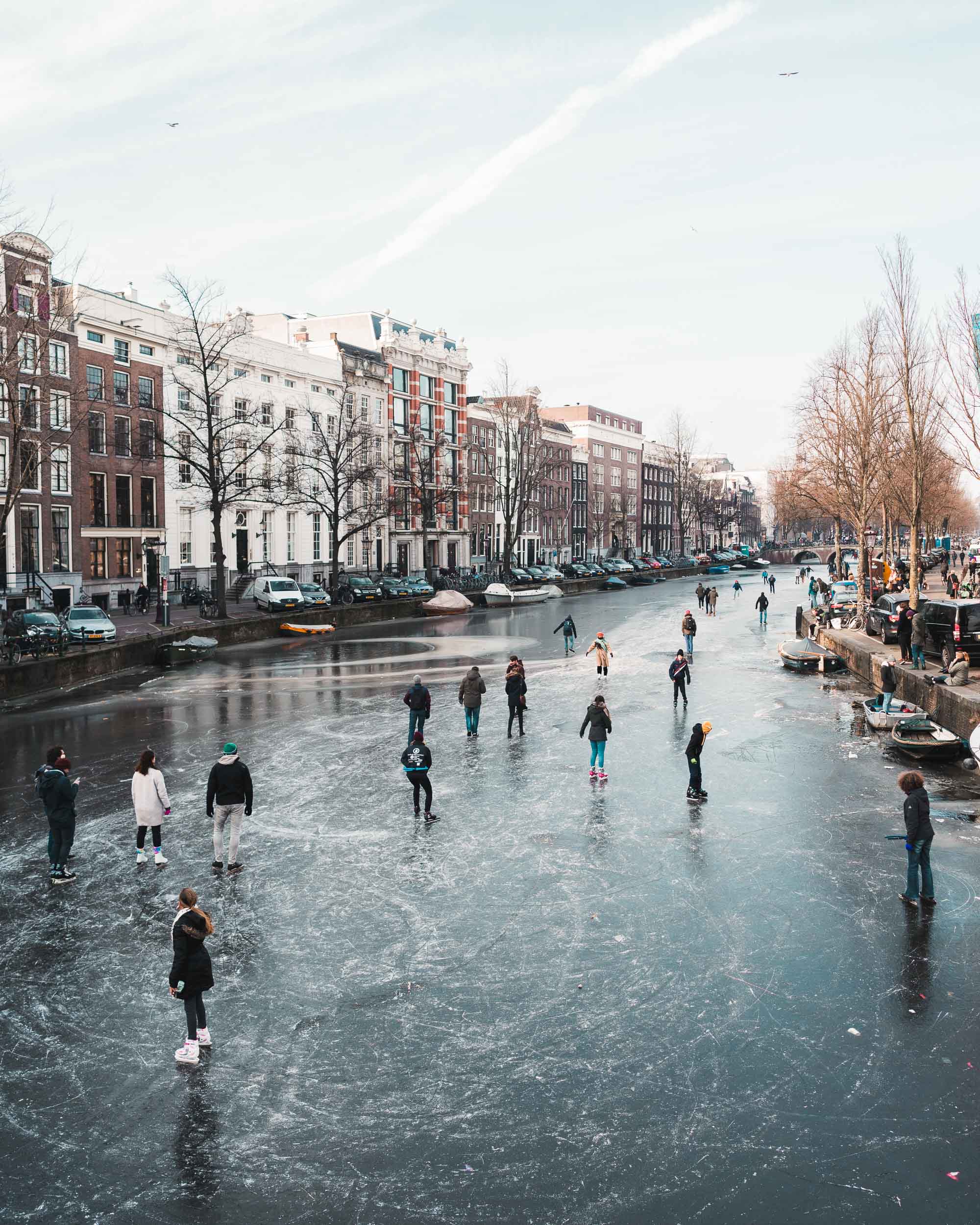 Ice skaters on the frozen canals in Amsterdam The Netherlands