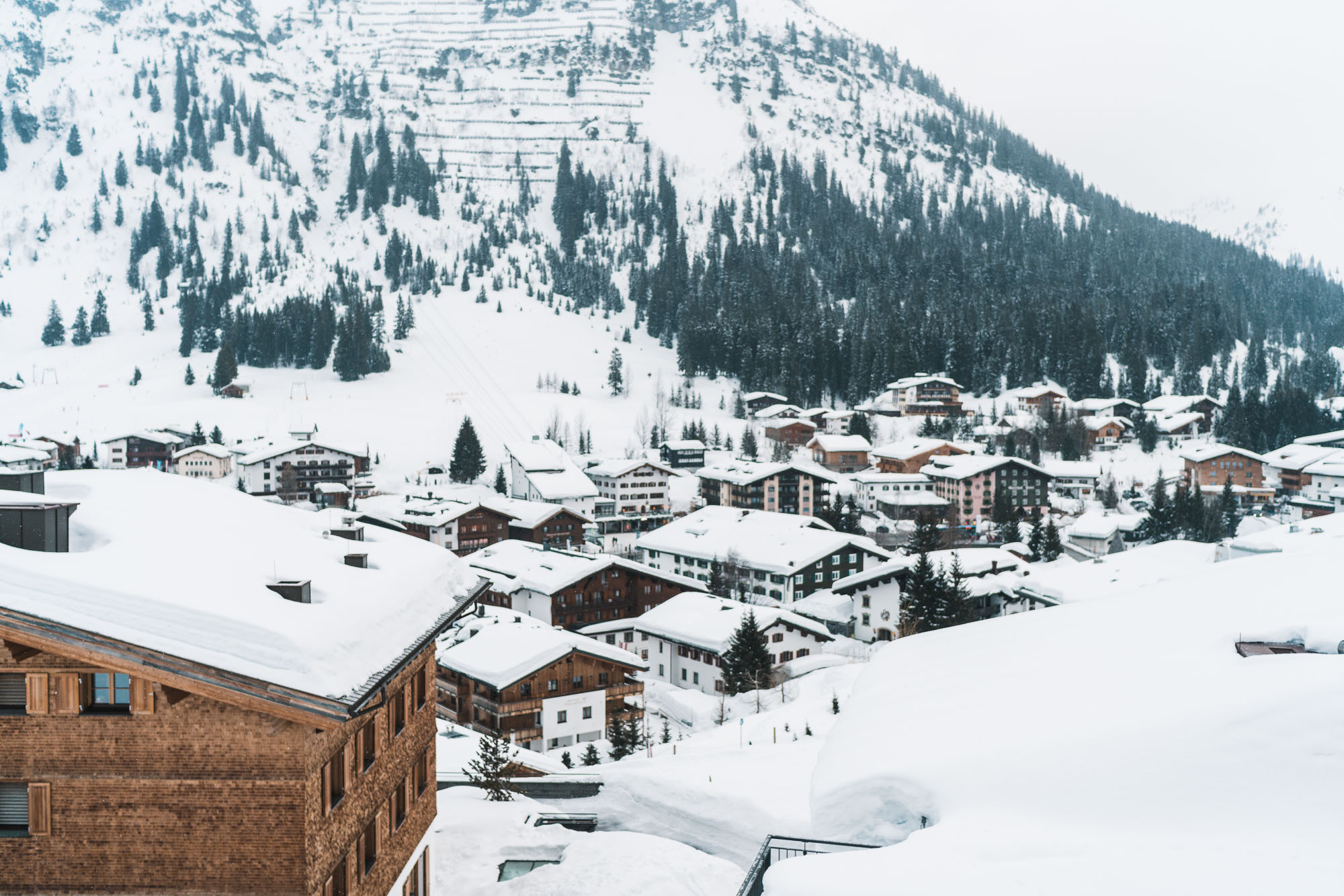 Snow-covered rooftops of hotels and restaurants downtown Lech Austria Ski Town
