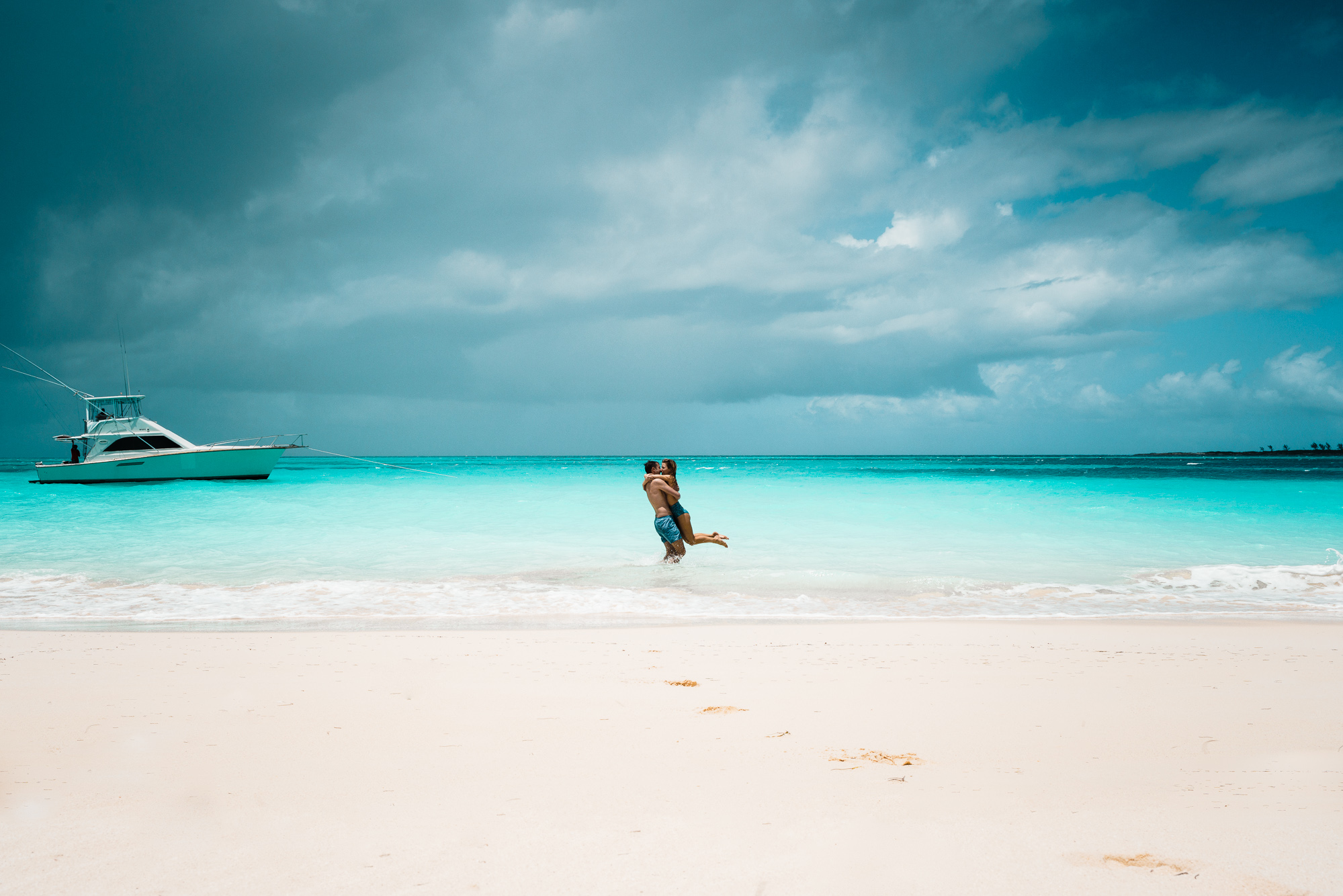 Couple kissing in clear blue water of Nassau Bahamas