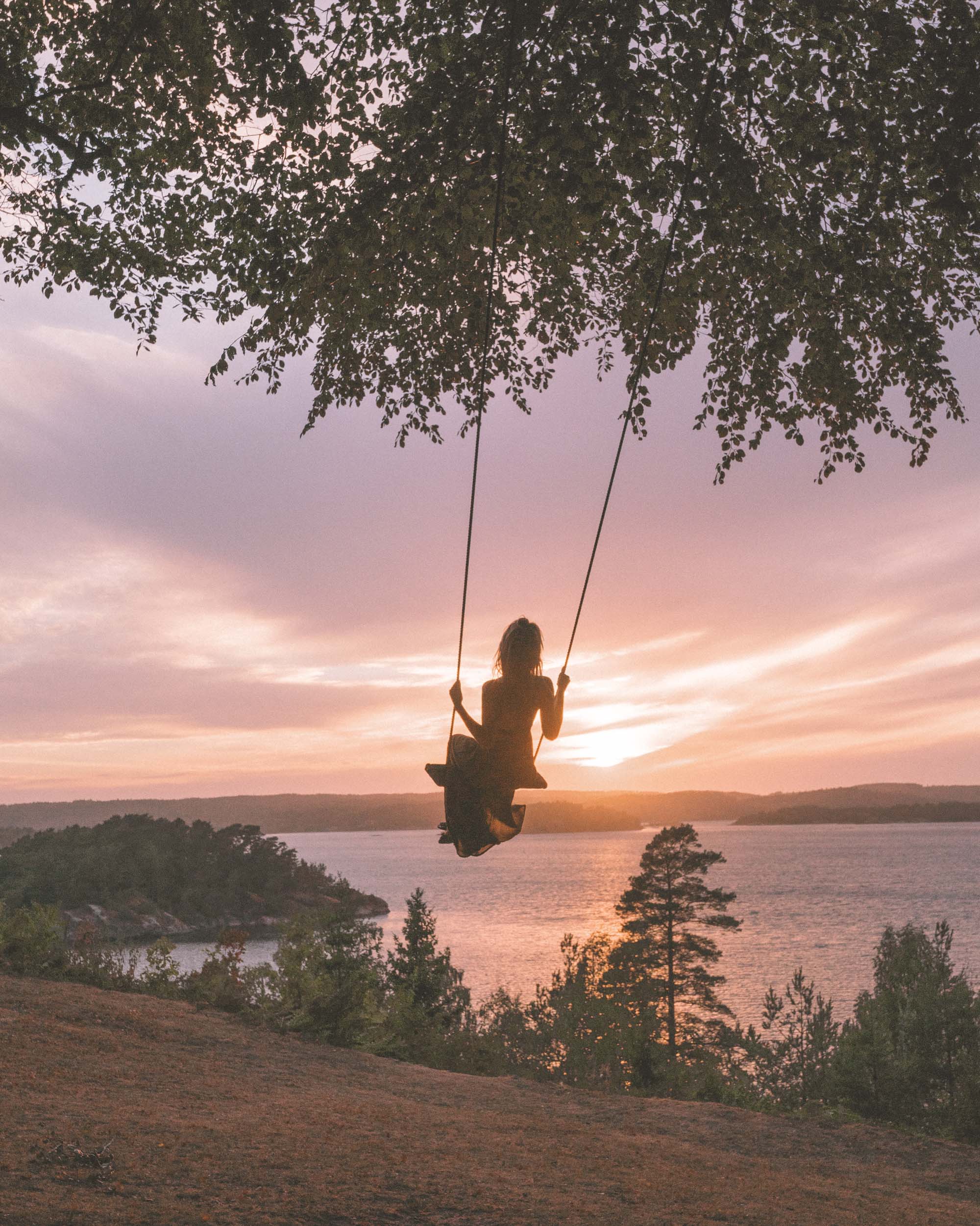 Swinging into the sunset over the west coast of Sweden in Ljungskile | West Sweden Travel Guide via @finduslost