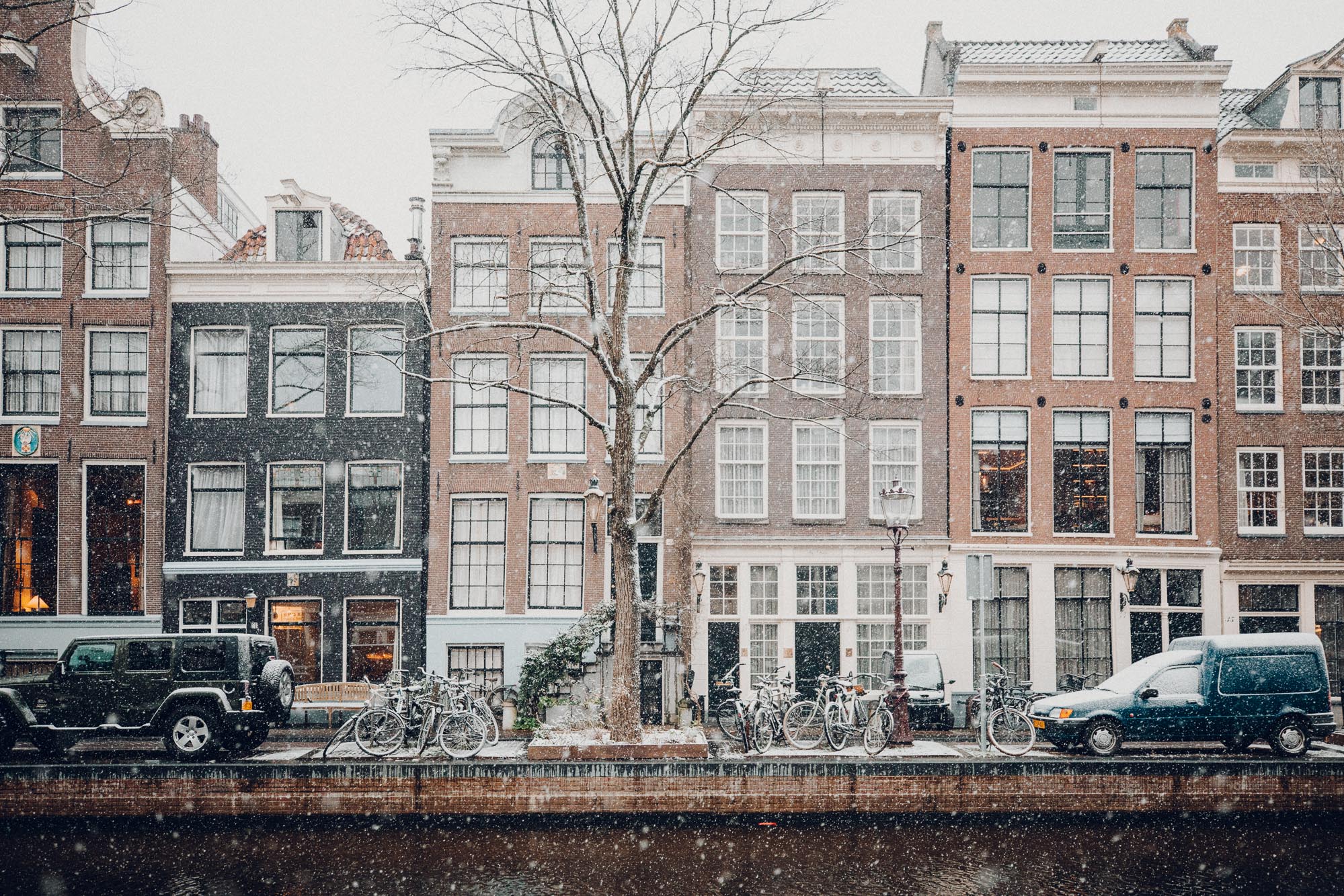 Amsterdam canal houses in the snow Find Us Lost