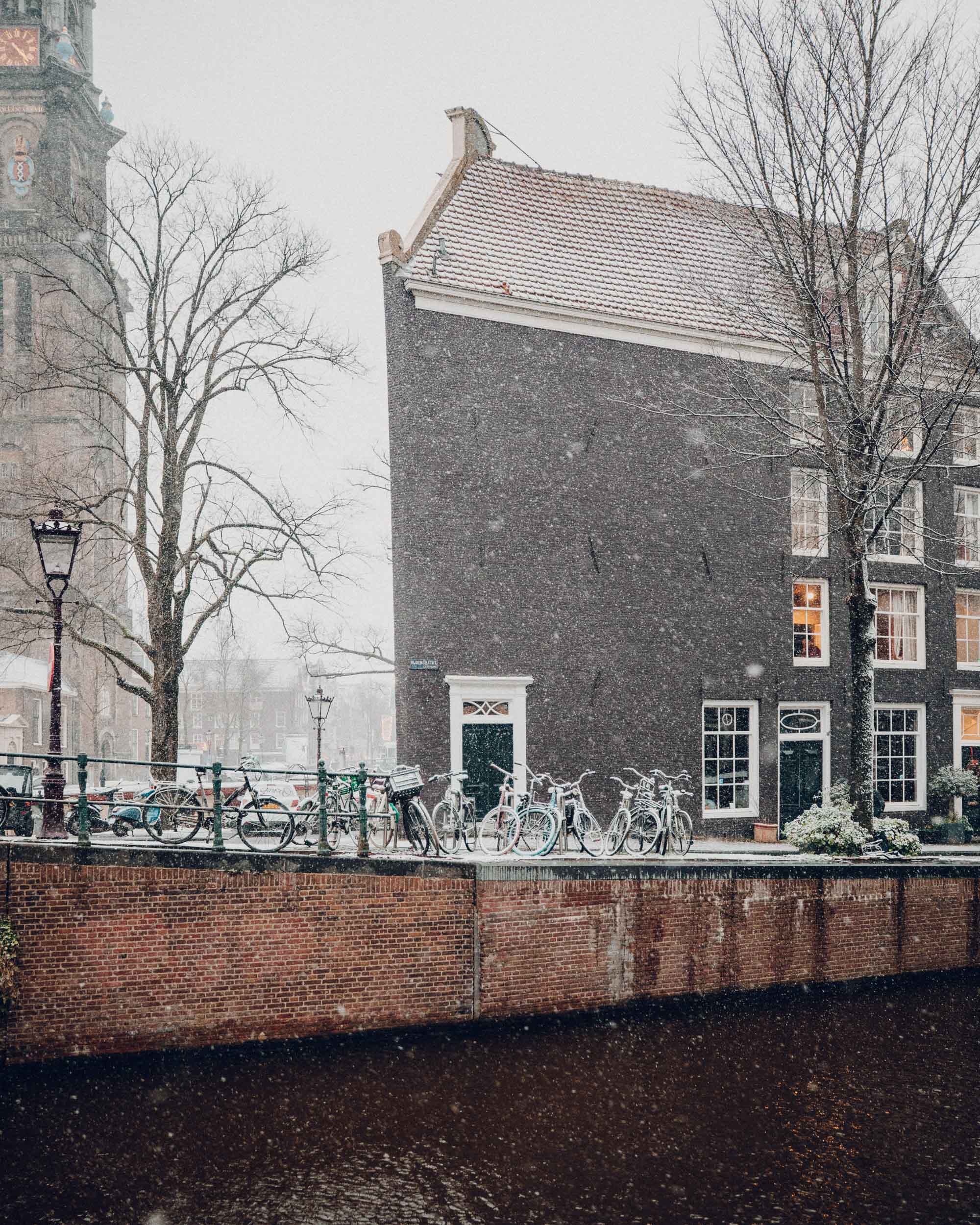 Amsterdam canal houses in the snow Find Us Lost